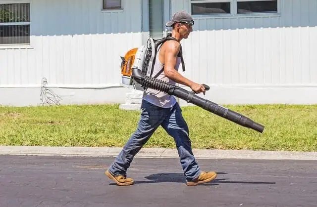 man in white tank top and blue denim pants with leaf blower 162564 1